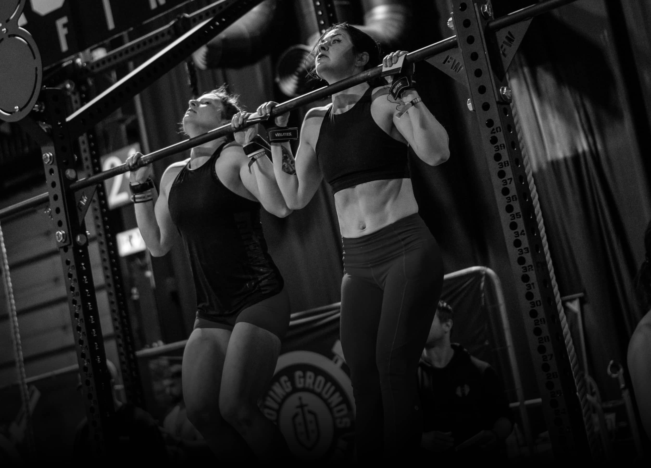 2 women doing pull ups